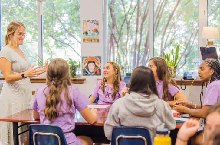 A GPS teacher leading a lively class discussion with students