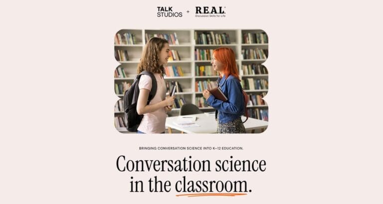 Two students talk while standing in a library. Above them, the logos for Talk Studios and R.E.A.L. are displayed, and below is the text: “Bringing conversation science into K-12 education. Conversation science in the classroom.”